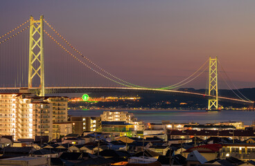 Akashi Suspension Bridge Lit with Rainbow Colors over City at Night