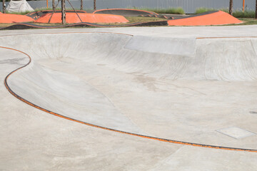 Concrete skatepark  with Tubes and Jumps at public park. sports near the house. ramp for extreme athletes.