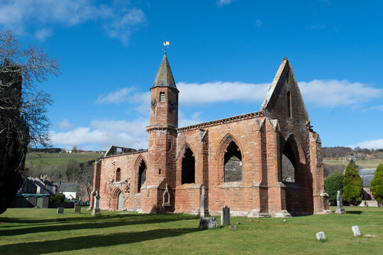Town centre of the Black Isle town of Fortrose in the Scottish Highlands with exterior view of the ruins of a medieval Cathedral.