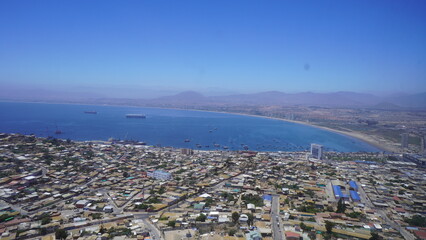 Obraz na płótnie Canvas aerial view of the bay in Coquimbo, Chile. You can see the town, the sea and some large ships
