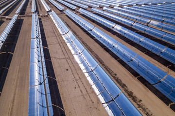 Fototapeta premium Solar thermal energy (STE) power plant. Mirrors heat water pipes to generate clean energy driving a turbine by water steam. Drone aerial.