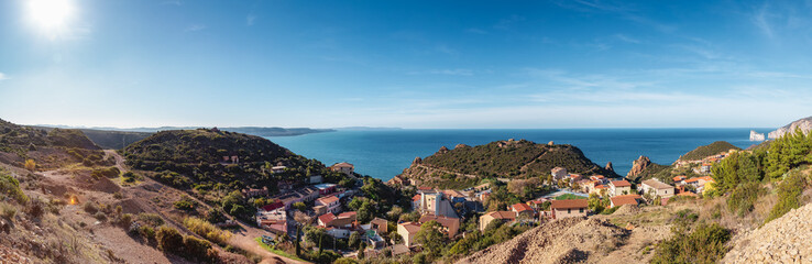 Fototapeta na wymiar Small Touristic Town, Nebida, on the Sea Coast. Sardinia, Italy. Sunny Day. Panorama