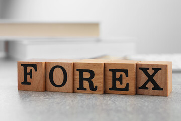 Word Forex made of wooden cubes with letters on grey table, closeup