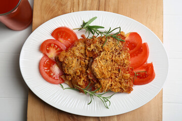 Tasty fried parsnips with fresh tomatoes and rosemary on white wooden table, top view