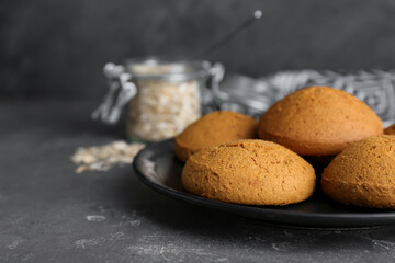 Delicious oatmeal cookies on grey table, closeup. Space for text
