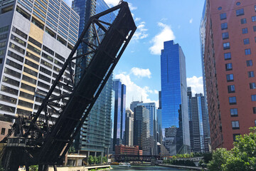 Obraz na płótnie Canvas Old Rail Bridge Up Over Chicago River With City Skyline