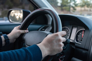Hands of a man on the wheel drive.