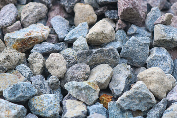 Gravel texture. Pebble stone background. Light grey closeup small rocks.
