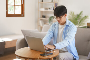 Fototapeta premium Business at home concept, Businessman typing on laptop about strategy and planning of new business