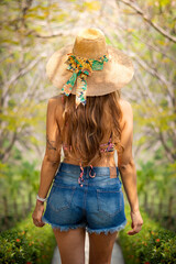 girl in a straw hat from the back