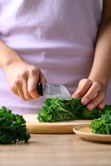 Green Kale or leaf cabbage cutting on wooden board, Healthy organic vegetable food ingredient