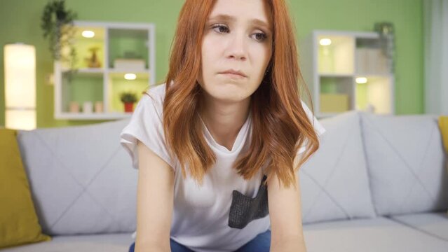 Unhappy thoughtful young woman thinking about her illness, thinking about her loneliness.
Desperate and depressed young woman at home thoughtful, separation, abandonment, thinking about grief, painful