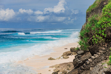 Tropical beach with ocean waves in Bali island