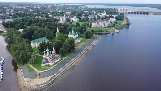Picturesque aerial view of modern townscape of Uglich overlooking dam on Volga River on summer day, Yaroslavl region, Russia. High quality 4k footage