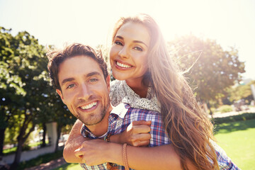 Couple portrait, smile and piggyback on love, valentines day or romance date in park bonding,...