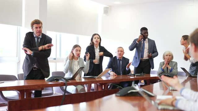 Businesspeople arguing at meeting in office Description: Multiracial group of age-diverse business people in formalwear having an emotional . High quality 4k footage