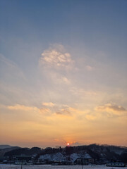 Rural winter landscape at sunset