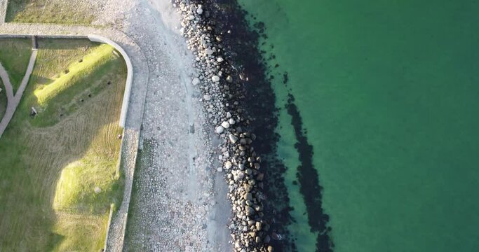 aerial view around kronborg castle denmark, near copenhagen, we see the waves crashing on the rocks of the beach