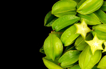 Averrhoa carambola fruits or starfruits isolated on black background  with space for text.