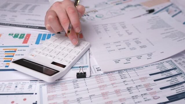 white calculator close, financial analyst checks financials 4k, slow motion, business concept