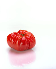 Big Red Heirloom Tomatoe on White Backdrop