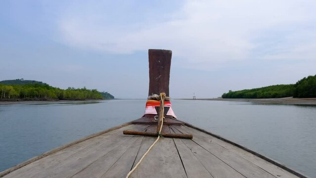 Shot of the front of a wooden boat in Thailand dropping off tourists at their destinations.