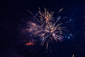 Inexpensive, budget, beautiful fireworks in the city, against the backdrop of the night sky.