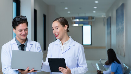 Both of doctors are analyzing the patient's MRI results on tablet to share ideas and discover new information for the patient's benefit in their treatment.