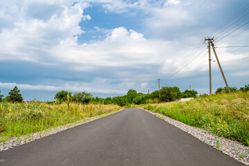 Fototapeta na wymiar Beautiful empty asphalt road in countryside on colored background