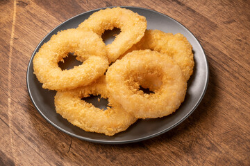 Cheesy Shrimp Doughnut or Shrimp tempura fried donuts on black plate on wooden background. Shrimp Doughnut