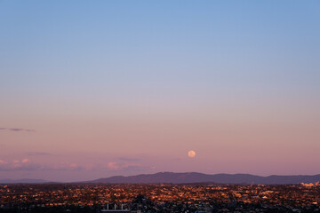 sunset over the city and moon