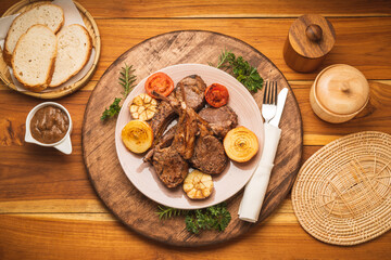 Lamp Rack Steak or Lamb chops Steak with rosemary, onion and tomato on wooden background.