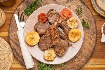 Lamp Rack Steak or Lamb chops Steak with rosemary, onion and tomato on wooden background.