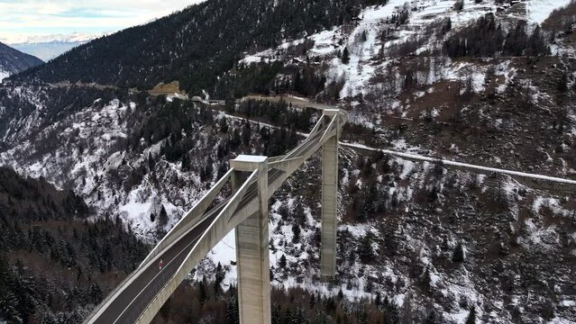 High modern Ganter Bridge on the way to the Simplon Pass between the high mountains in the Swiss alps in wintertime. Drone dolley shot