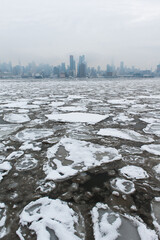 New York skyline and Hudson River freezing over in winter