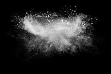 White powder explosion cloud against black background. White dust particles splash.