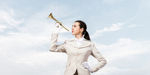 Beautiful woman playing trumpet brass