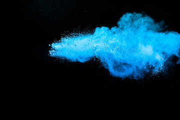 Blue powder explosion cloud on black background.Launched blue dust particles splash.