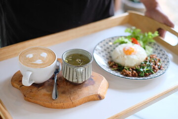 Coffee and Rice top with boiled egg and stir-fried mince pork with basil.