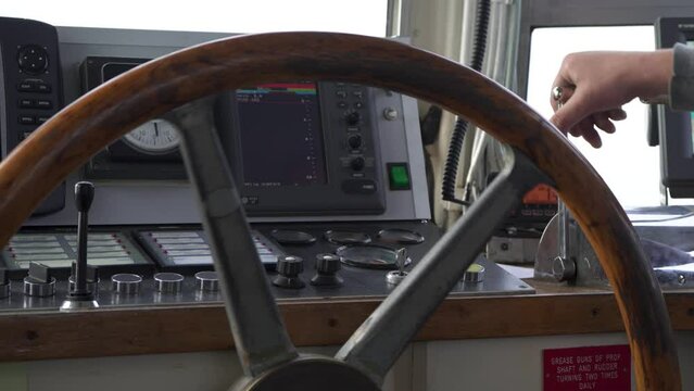 Boat. Steering wheel rotates. Hand turns throttle. Control panel behind.