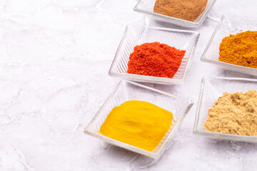 Various dried spices in small bowls