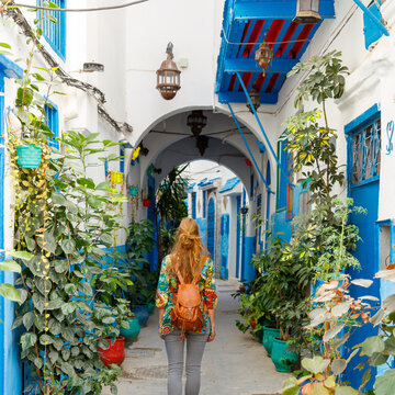 tourism at Tanger,  woman walking in typical moroccan street