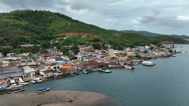 Aerial moving panoramic view of small Venezuelan town of Mochima in Mochima National Park. Venezuela.