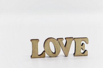 Wooden inscription love on a white background