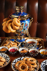 Russian character - a samovar. A bunch of bagels. Homemade jam. Patties. Russian food.