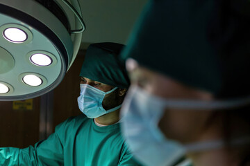 doctor putting medical tape tube patient for infusion operation. expert surgeon performing stick tape to attach tube. professional surgery staff attach iv bag cord to person arm with adhesive tape