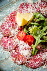 beef carpaccio with lemon and salad