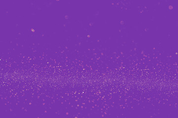Gold shining particles on purple background. Abstract image