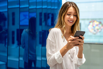 Portrait of happy beautiful smiling business woman using mobile phone. Technology people concept
