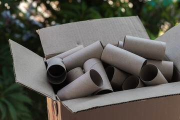Brown box containing a lot of toilet paper tube for children in kindergarten to create a toy or DIY...